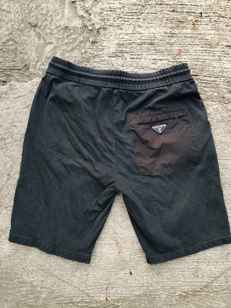 Prada Black Sweatshorts with Back Pocket (Category: Shorts) located in Manila. Submitted by arjaygoodfind (Listing ID 1466151709, Image 2). Description: - Authentic Prada sweatshorts in versatile black - Premium soft cotton material for all-day comfort - Size: XL with a standard fit and adjustable drawstring waistband - Features branded aglets and a convenient single back pocket - Accented with the iconic Prada enamel triangle logo on a contrast 