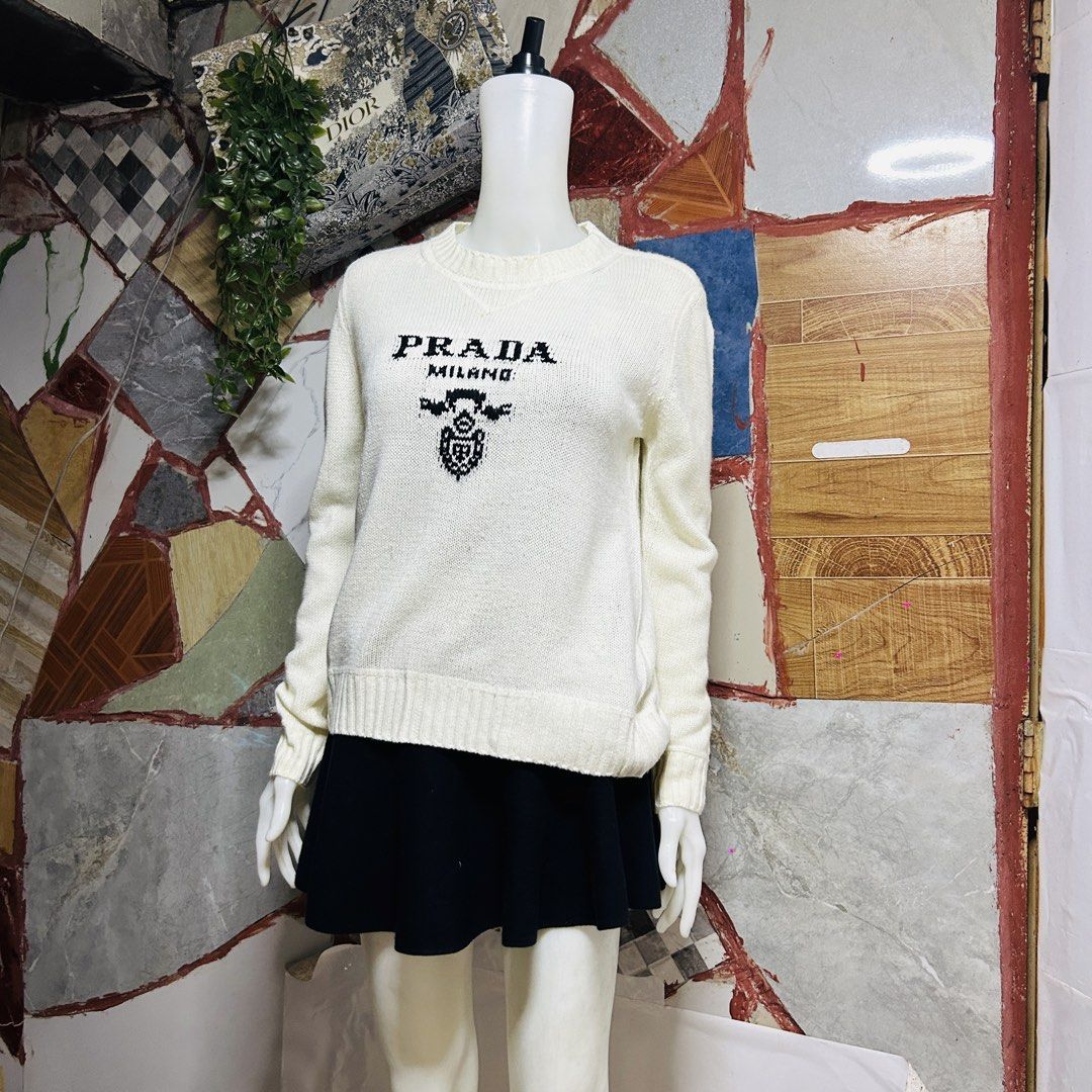 Prada knit-sweater (Category: Luxury Apparel) located in Baguio. Submitted by kckc_luxury (Listing ID 1466082252, Image 2). Description: 🌸 TINY PINK SPOTS ARE LENS DAMAGE, NOT CLOTH STAINS ————————— ❗️KINDLY READ BEFORE MAKING AN OFFER❗️ LISTING DETAILS size:M width x length (inches):23x25 condition: EXCELLENT --- MOP: Gcash / BPI MOD: J&T / JRS LOCATION: Baguio City --- NOTE: • Manage your expectations • Photos did not go under any edit but col
