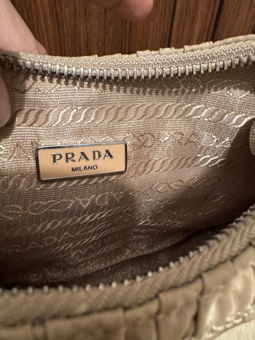 Prada Ruched Nylon Shoulder Bag Beige (Category: Luxury Bags & Wallets) located in Cauayan City . Submitted by espiritucj (Listing ID 1465984650, Image 3). Description: Thrifted Pc. -Prada shoulder bag in a chic beige ruched nylon design - Features durable Saffiano leather strap and sleek silver-tone hardware - Secure top zip closure for your daily essentials - Signature jacquard lining throughout the interior - Includes interior Prada logo plaqu