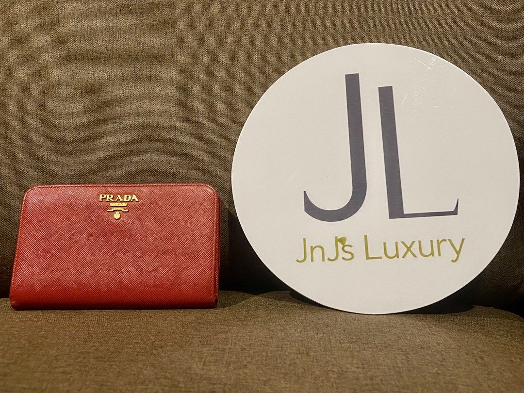 Prada Saffiano Metal Red Zip Around Wallet (Category: Wallets & Card holders) located in Manila. Submitted by jnjsluxury (Listing ID 1465960656, Image 2). Description: - Authentic Prada zip-around wallet in vibrant red Saffiano leather - gold-tone hardware featuring the classic Prada Milano logo - Organized interior with multiple card slots, bill compartments, and a secure zipped coin pocket - Pristine and well-maintained condition for both inter