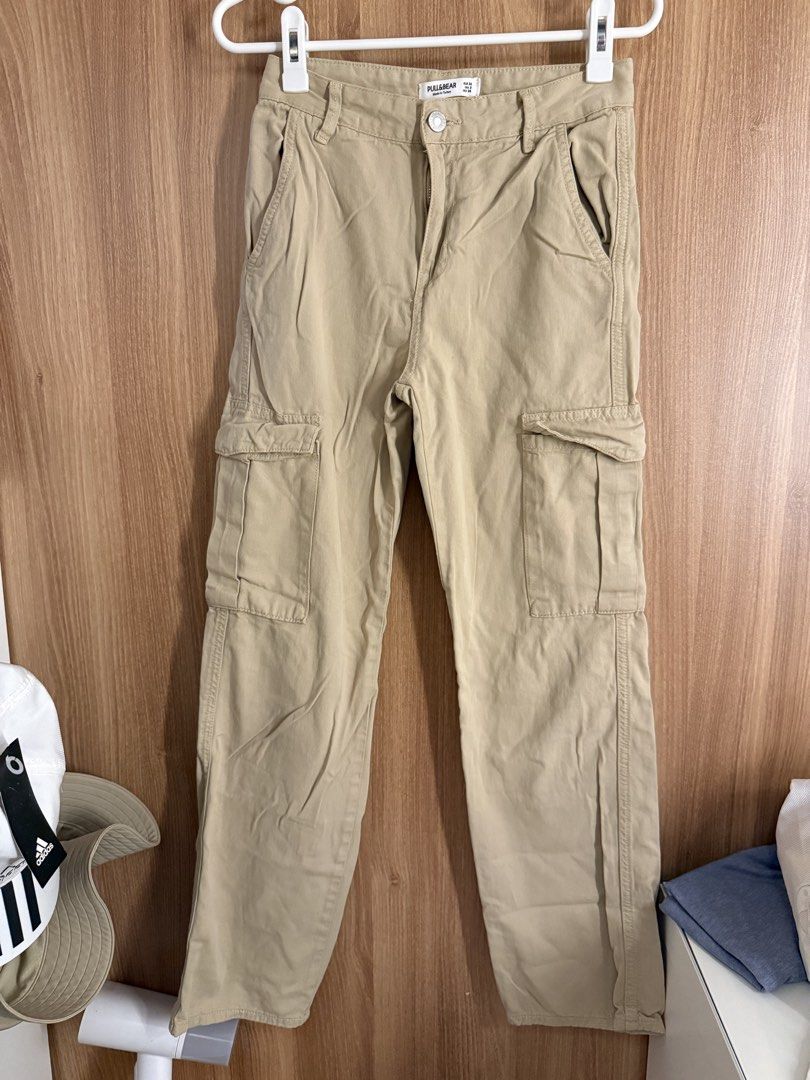 Pull & Bear Beige Cargo Pants (Category: Jeans) located in Manila. Submitted by conradfisher (Listing ID 1466125172, Image 1). Description: - Brand: Pull & Bear - Color: Khaki Beige - Size: EUR 34 / US 2 / MEX 24 - Style: Utility cargo pants with side flap pockets, back pockets, and belt loops - Origin: Made in Turkey - Condition: Clean, well-maintained, and versatile piece.