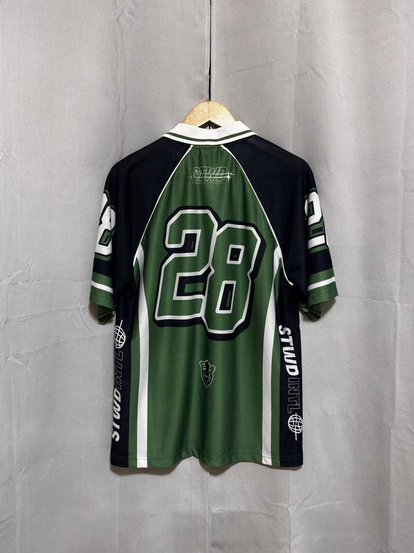 Pull & Bear STWD Green Black Jersey Number 28 (Category: Activewear) located in Quezon City. Submitted by aintdistance (Listing ID 1466116934, Image 2). Description: - Color: Green and black - Design: Collared neck with button placket, large number 28 front and back - Details: STWD INTL lettering and globe graphics on sleeves - Fit: Loose fit, lightweight fabric - Style: Ideal for streetwear looks .