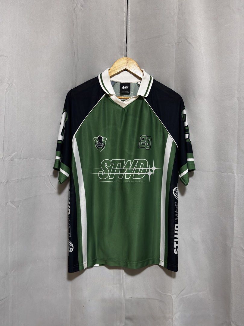 Pull & Bear STWD Green Black Jersey Number 28 (Category: Activewear) located in Quezon City. Submitted by aintdistance (Listing ID 1466116934, Image 1). Description: - Color: Green and black - Design: Collared neck with button placket, large number 28 front and back - Details: STWD INTL lettering and globe graphics on sleeves - Fit: Loose fit, lightweight fabric - Style: Ideal for streetwear looks .