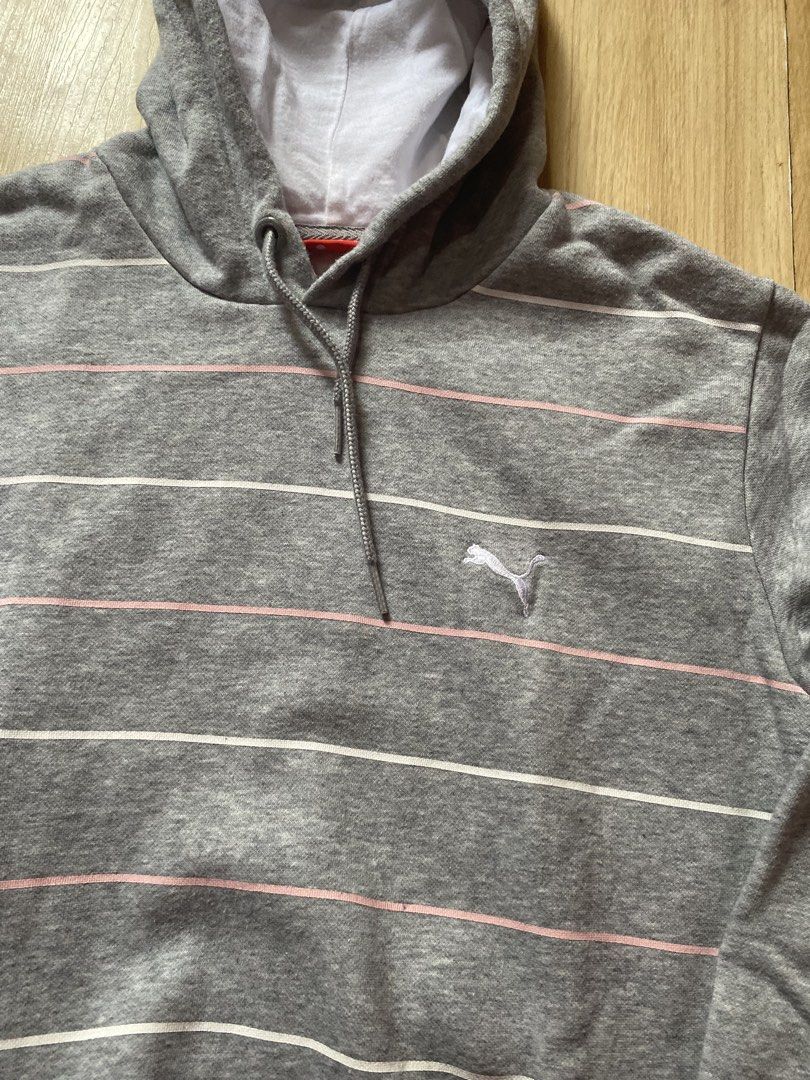 Puma Striped Grey Hoodie (Category: Coats, Jackets and Outerwear) located in Tanauan. Submitted by rie098 (Listing ID 1466040408, Image 2). Description: - Brand: Puma - Style: Grey hoodie with horizontal pink and white stripes - Size: UK 14 - Material: 80% cotton, 20% polyester (Made in Malaysia) - Features: Drawstring hood with white lining, front kangaroo pocket, and embroidered chest logo - Condition: Excellent / Pre-loved (ready to wear).