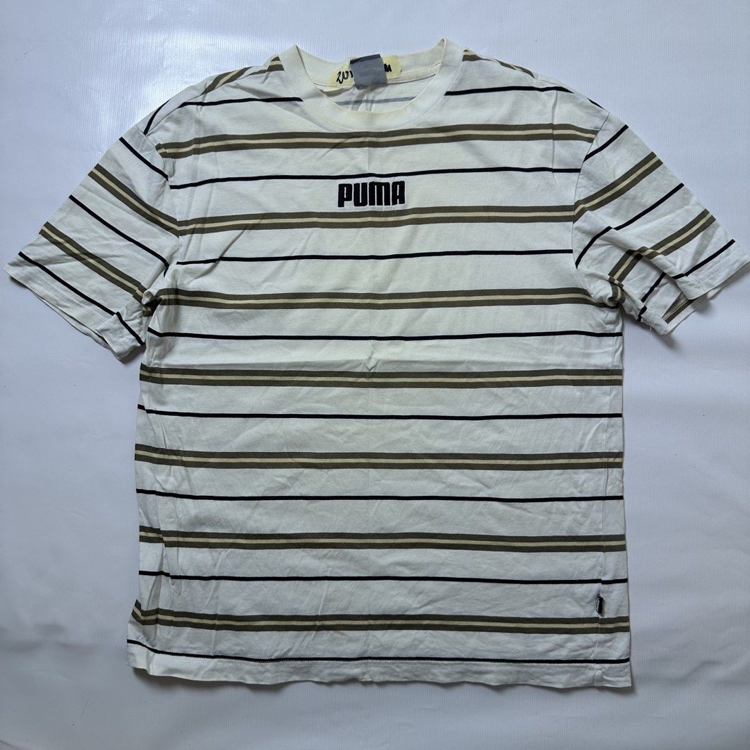 Puma Striped T-Shirt (Category: Tshirts & Polo Shirts ) located in Gapan. Submitted by rasthriftshop (Listing ID 1466123102, Image 1). Description: PUMA Size on tag: M Dimes: 20 x 27 ₱350 + sf Condition: Excellent Color rate: 9/10 Issue: None.