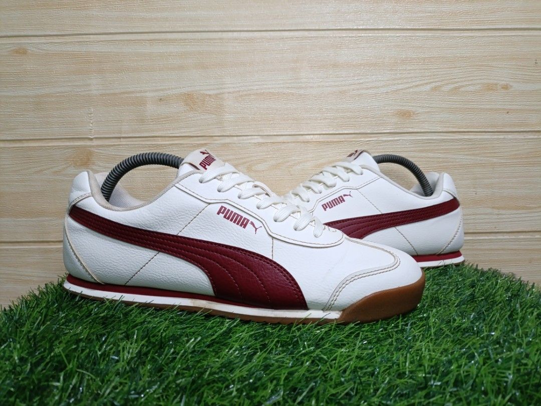 Puma Torino ll (Category: Sneakers) located in Davao. Submitted by tomcarbon11 (Listing ID 1466120855, Image 2). Description: - Brand/Model: Puma Retro Low-Top Sneakers - Colorway: White leather with striking deep red side stripes - Soles: Durable brown gum rubber with herringbone traction pattern - Condition: Clean uppers, minor wear on outsoles - Style: Classic vintage look, perfect for everyday casual wear - Laces: Original white laces include