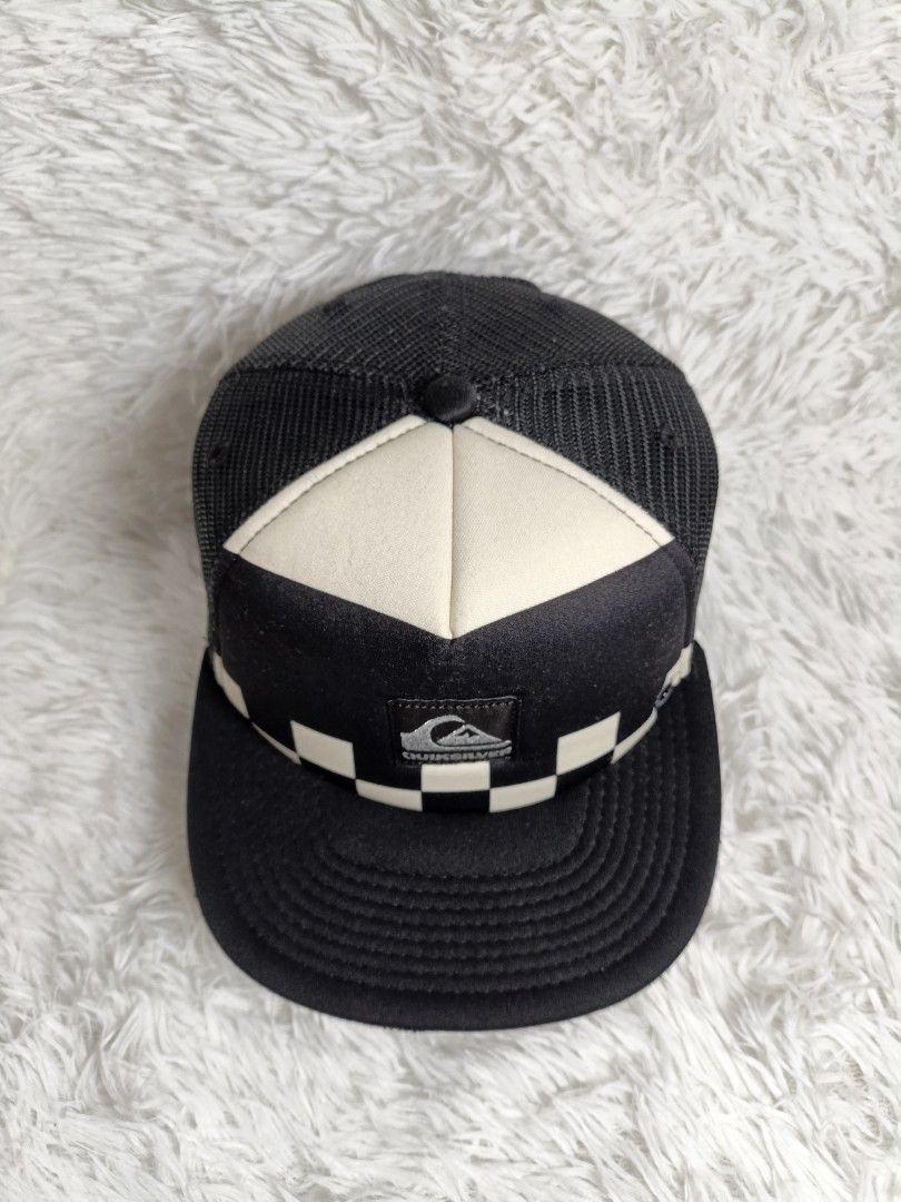 Quiksilver Checkered Trucker Hat Black White (Category: Caps & Hats) located in Imus. Submitted by grindhouse.thriftshop (Listing ID 1466122886, Image 2). Description: - Brand: Quiksilver - Design: Black and white checkerboard foam front with embroidered logo patch - Ventilation: Breathable black mesh back/sides and front eyelets - Brim: Flat brim design - Closure: Adjustable plastic snapback with brand tab - Condition: Excellent / Ready to wear 