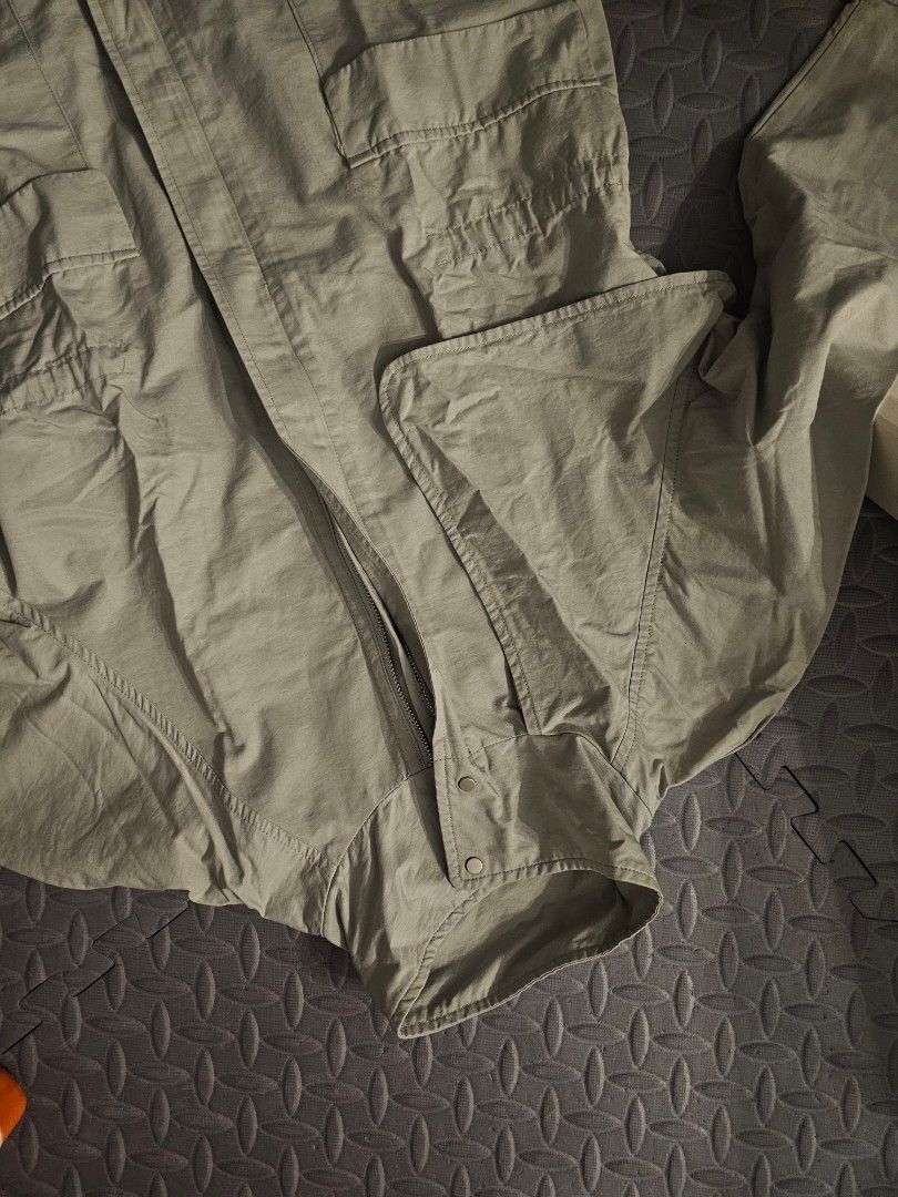 Qye Style Beige Utility Jumpsuit with Pockets (Category: Jumpsuits) located in Manila. Submitted by john.tulalian (Listing ID 1466128402, Image 3). Description: - Brand/Style: Qye Style beige utility jumpsuit - Closure: Full front metal zipper with a classic collar - Pockets: Functional chest and hip flap pockets - Sleeves: Long sleeves with structured cuffs - Material: Lightweight fabric - Versatility: Ideal for casual days or edgy outdoor styli