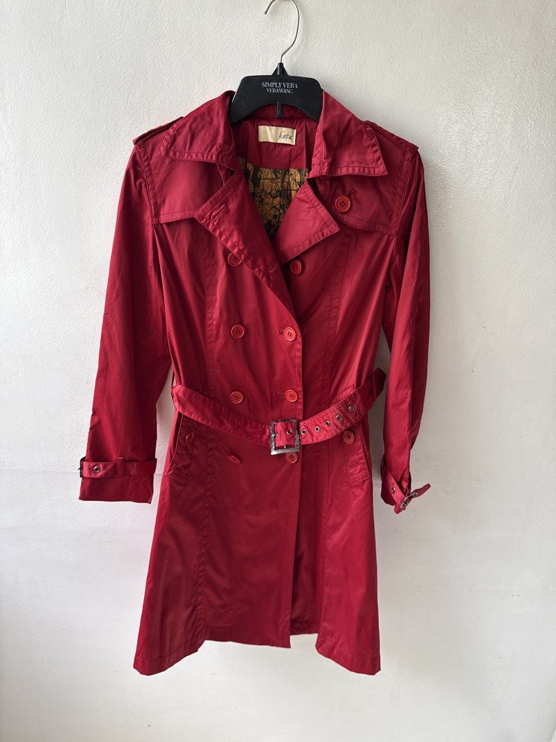 Red Double-Breasted Trench Coat with Belt (Category: Coats, Jackets and Outerwear) located in Quezon City. Submitted by dropdeadprices (Listing ID 1465998144, Image 1). Description: - Brand: Katz - Color: Red with gold patterned lining - Style: Double-breasted trench coat with mid-length cut - Details: Matching red buttons, adjustable waist belt, cuff buckle straps, shoulder epaulets, and back vent - Fabric: Lightweight and comfortable - Conditio