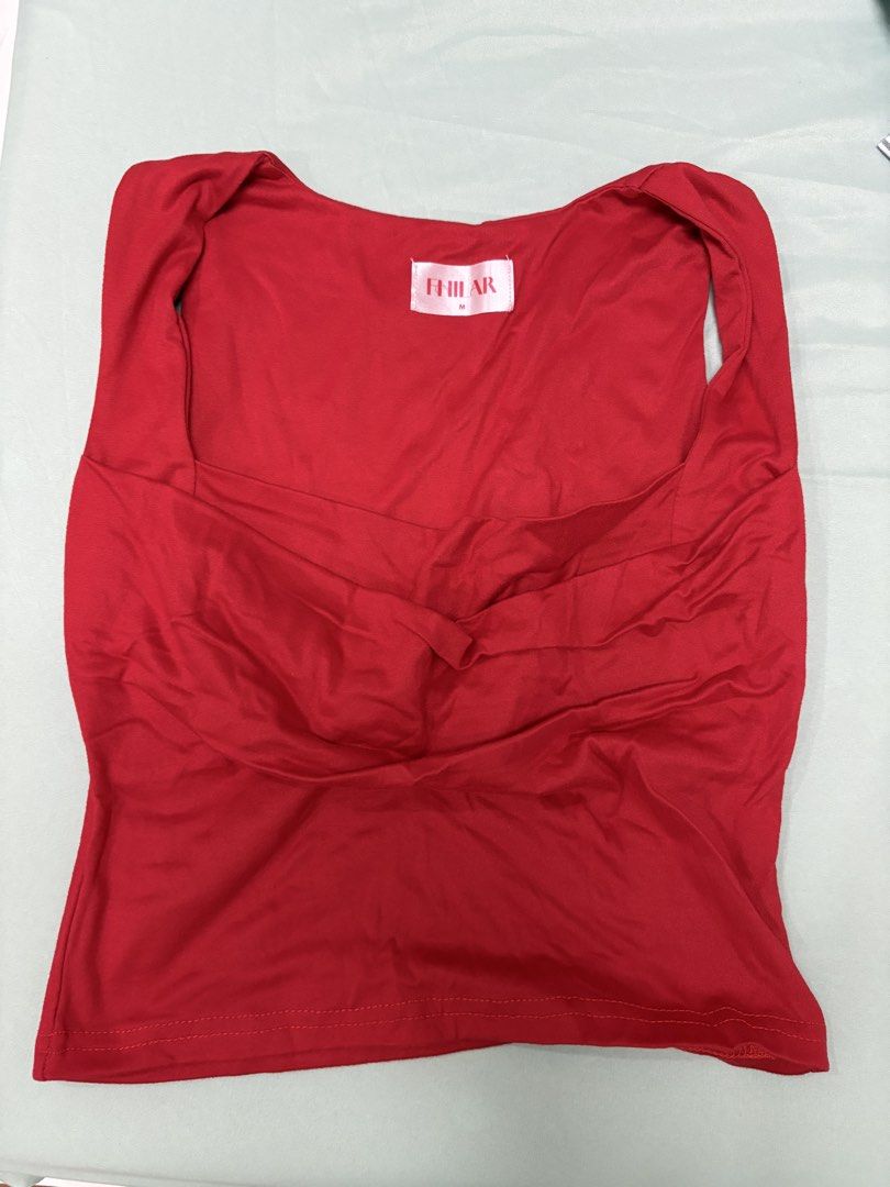 Red Sleeveless Top Size M (Category: Sleeveless) located in San Juan City. Submitted by moon.riverandme (Listing ID 1466112742, Image 1). Description: - Size: M (tag attached) - Color: Bright Red - Style: Sleeveless top with square neckline - Design: Unique folded fabric detail on front chest, plain solid back - Material: Soft and stretchy for comfortable wear .