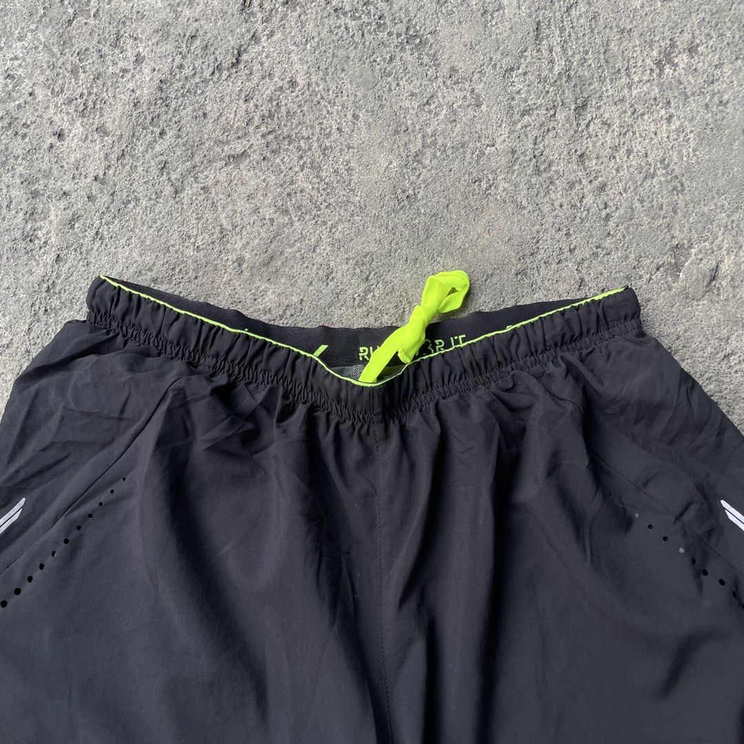 Reebok Black Running Shorts with Built-In Compression Liner (Category: Shorts) located in Polangui. Submitted by b0ssl00ts (Listing ID 1465962285, Image 2). Description: - Brand: Reebok - Color: Black with neon yellow drawstring and trim - Liner: Built-in grey compression liner for added support - Ventilation: Laser-cut side holes for maximum airflow - Details: Reflective silver accents and classic white Reebok logo on the left leg - Condition: B