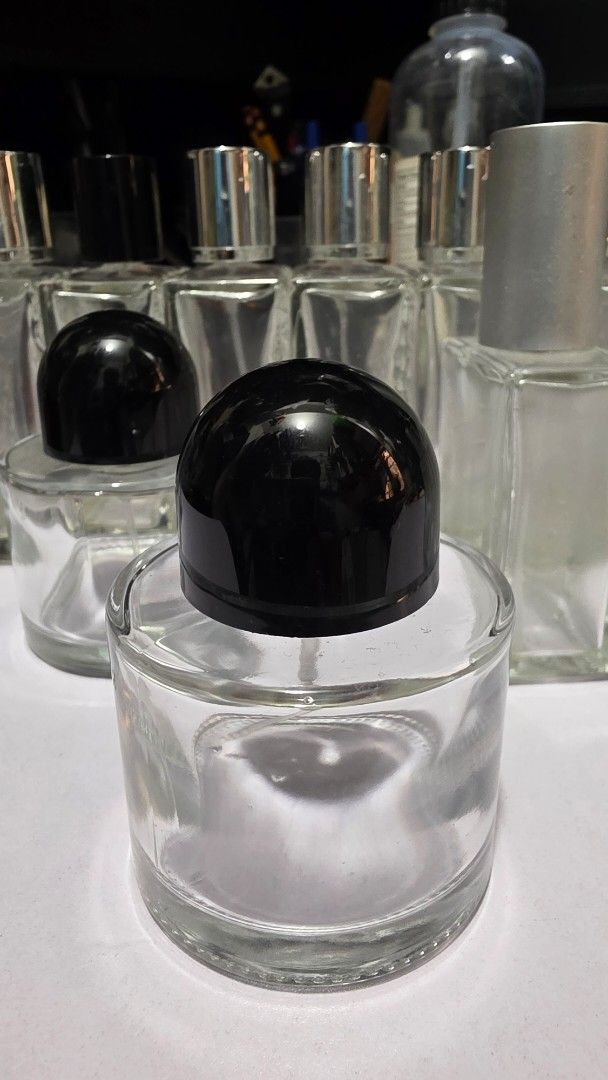 Refillable Perfume Bottles (Category: Fragrance & Deodorants) located in Makati City. Submitted by _antukin (Listing ID 1466015965, Image 2). Description: - Type: Assorted clear glass perfume bottles with spray atomizers - Condition: Clean and empty, ready for use - Designs: Rectangular textured and smooth round shapes - Caps: Includes both silver and black caps - Best for: Decanting perfumes or creating DIY fragrances - Availability: Multiple pi