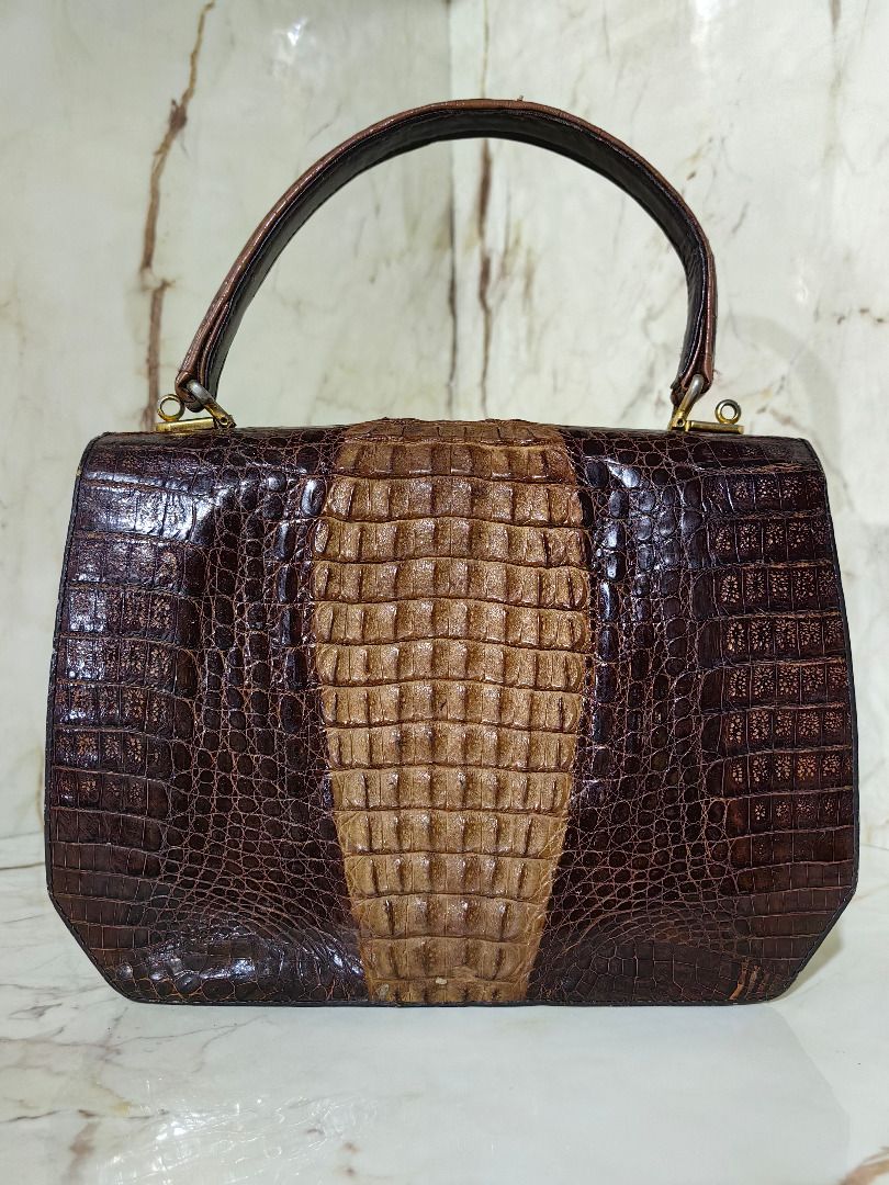 Regarde Crocodile Skin Handbag Brown (Category: Clutches) located in Tarlac. Submitted by jeremiah.curator.2026 (Listing ID 1466005558, Image 3). Description: - Authentic Regarde handbag made from genuine crocodile skin - Striking two-tone brown color with a lighter hornback center panel and darker sides - Elegant single top handle and secure metal clasp closure on the front flap - Interior metal brand plaque stamped with Regarde Crocodile Skin f