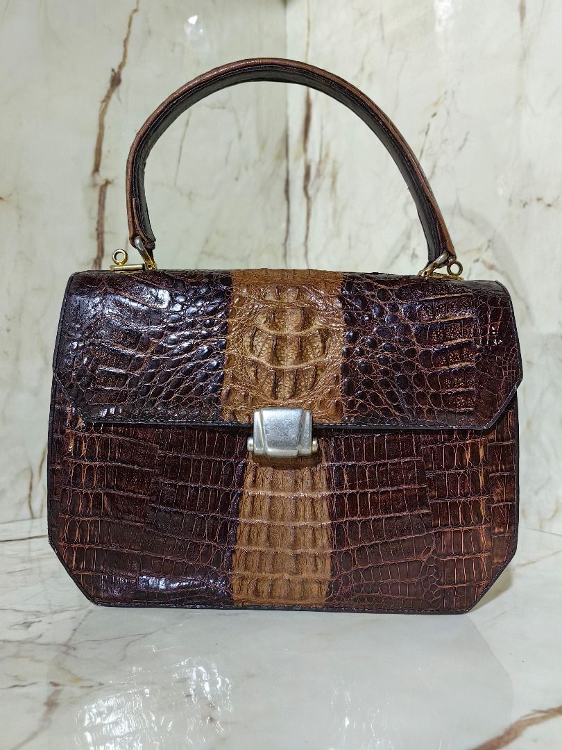 Regarde Crocodile Skin Handbag Brown (Category: Clutches) located in Tarlac. Submitted by jeremiah.curator.2026 (Listing ID 1466005558, Image 1). Description: - Authentic Regarde handbag made from genuine crocodile skin - Striking two-tone brown color with a lighter hornback center panel and darker sides - Elegant single top handle and secure metal clasp closure on the front flap - Interior metal brand plaque stamped with Regarde Crocodile Skin f