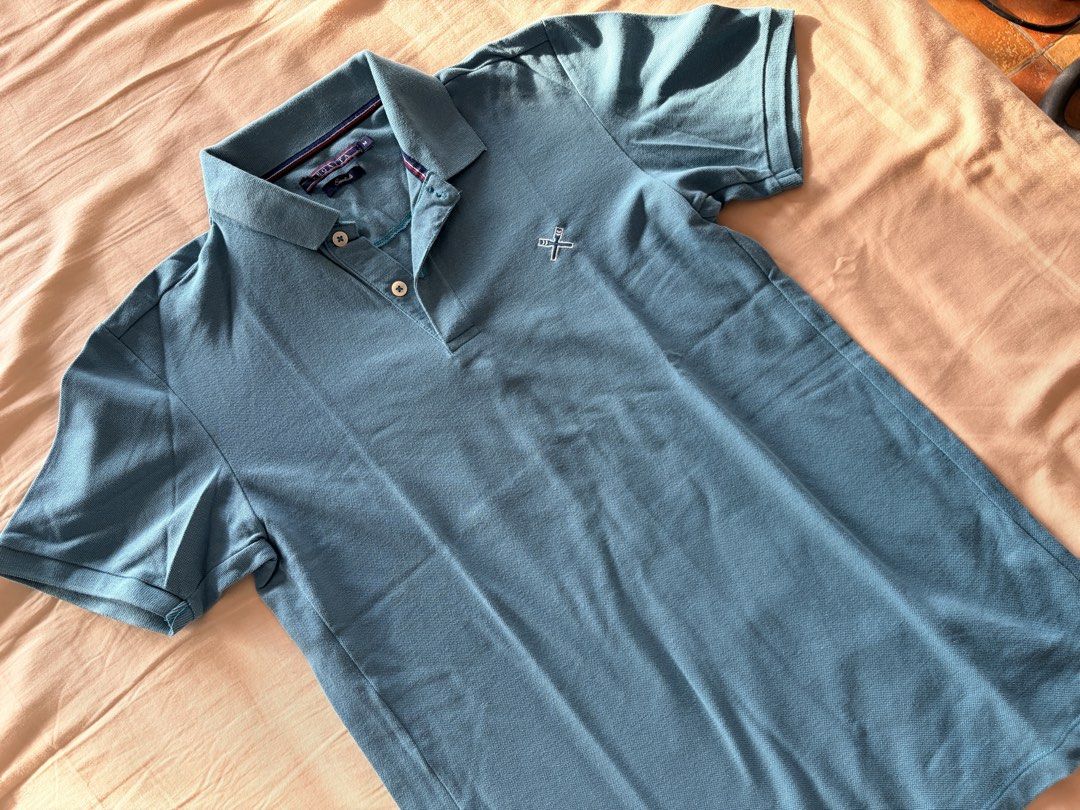 Regatta Essentials Blue Polo Shirt Size M (Category: Tshirts & Polo Shirts ) located in Quezon City. Submitted by makingroomfinds (Listing ID 1466062065, Image 2). Description: - Brand: Regatta Essentials - Style: Polo shirt with classic collar and two-button placket - Color: Blue - Size: Medium - Material: Comfortable and breathable cotton pique - Features: Short sleeves with ribbed cuffs and small embroidered logo on the chest - Condition: Grea