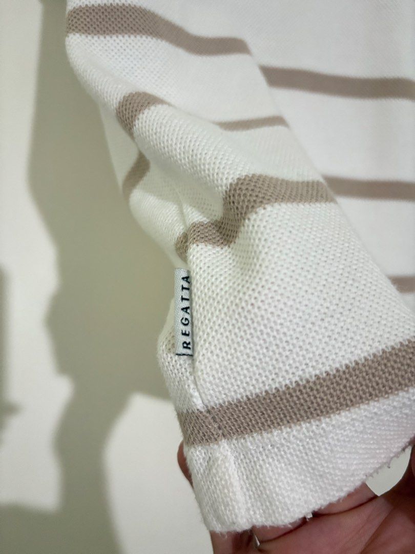 Regatta Striped Knit T-Shirt (Category: Tshirts & Polo Shirts ) located in Taguig. Submitted by marbsanne (Listing ID 1466068933, Image 2). Description: - Brand: Regatta - Design: Brown and white horizontal stripes with textured knit fabric - Details: Embroidered crossed oars logo on chest and branded label near hem - Fit & Style: Crew neck, standard fit, short sleeves - Condition: Clean, breathable material, and ready to wear.