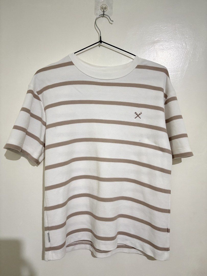 Regatta Striped Knit T-Shirt (Category: Tshirts & Polo Shirts ) located in Taguig. Submitted by marbsanne (Listing ID 1466068933, Image 1). Description: - Brand: Regatta - Design: Brown and white horizontal stripes with textured knit fabric - Details: Embroidered crossed oars logo on chest and branded label near hem - Fit & Style: Crew neck, standard fit, short sleeves - Condition: Clean, breathable material, and ready to wear.