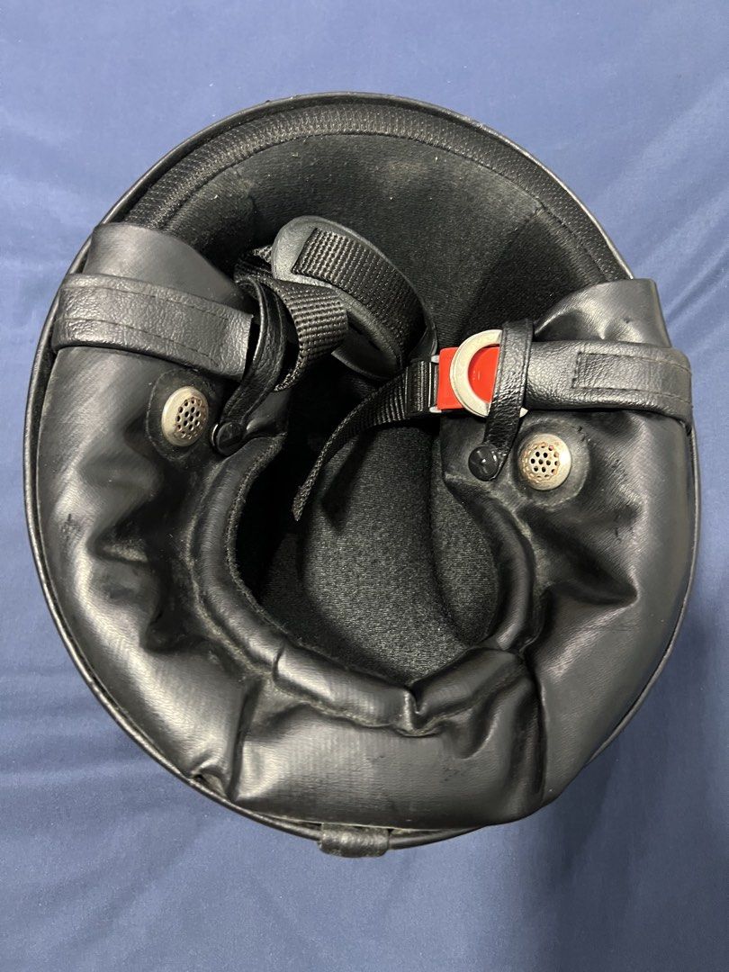Retro Black and Silver Motorcycle Half Helmet (Category: Bicycles) located in Quezon City. Submitted by swoosh24 (Listing ID 1465972114, Image 3). Description: - Style: Black helmet with striking silver racing stripe - Interior: Comfortable black leather lining with perforated metal vent buttons - Closure: Secure and reliable buckle fastening mechanism - Condition: Minor surface scuffs from previous handling.