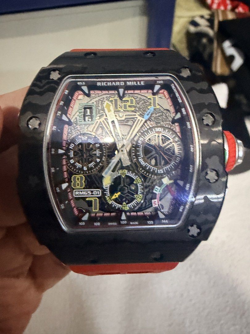 Richard Mille RM 65-01 Automatic Split-Seconds Chronograph (Category: Luxury Watches) located in Quezon City. Submitted by BAYMAX72 (Listing ID 1465975711, Image 1). Description: - Model: Richard Mille RM 65-01 Automatic Split-Seconds Chronograph - Case: Carbon TPT with signature layered texture - Strap: Vibrant red rubber with secure buckle closure - Dial: Multi-layered skeleton with detailed sub-dials and luminous hands - Movement: Swiss-made a