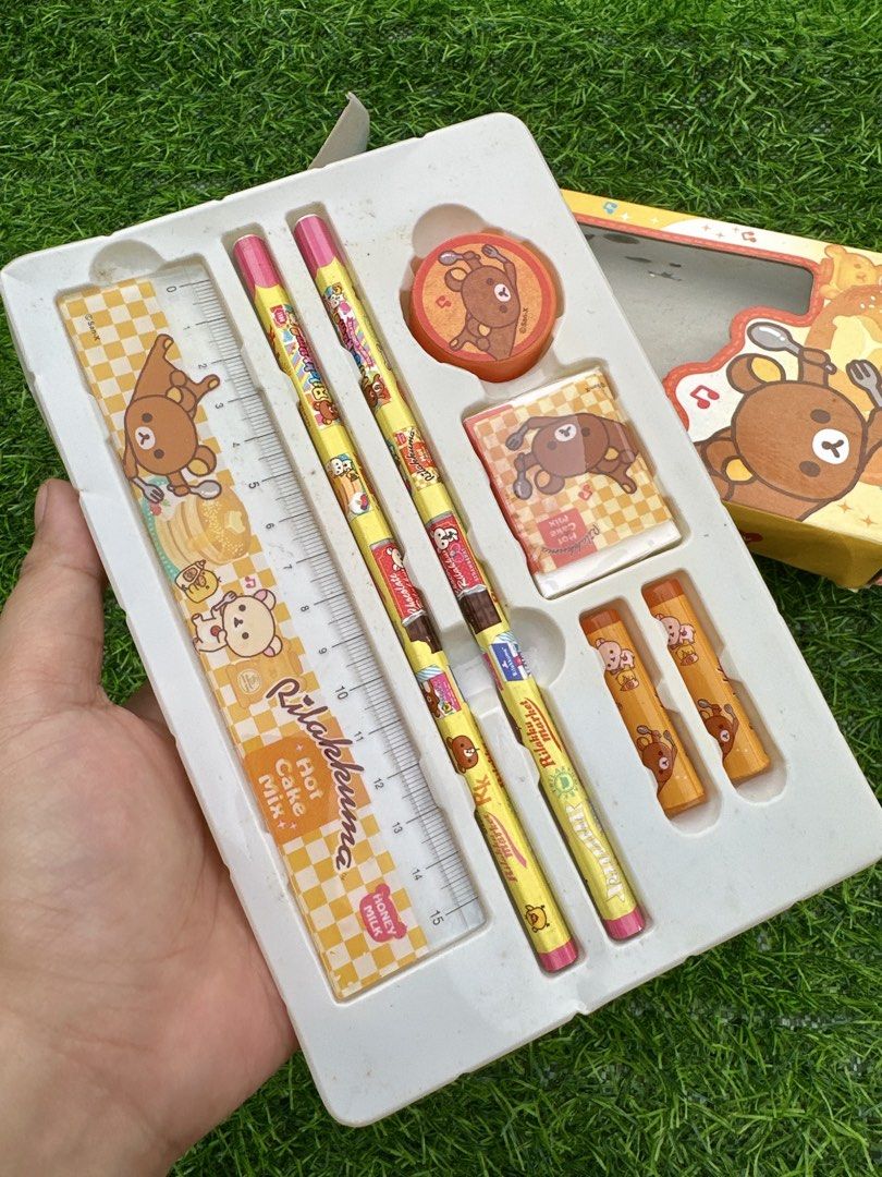 Rilakkuma Hot Cake Mix Stationery Gift Set (Category: Stationery & School Supplies) located in Manila. Submitted by ronoarabbit.ph (Listing ID 1466048896, Image 2). Description: ‼️Ngarag na ung box, bawal sa maarte‼️ - Theme: Rilakkuma Honey Milk Pancake - Colorway: Yellow, orange, and brown - Inclusions: 2 pencils, 1 ruler, 2 small caps, 1 eraser, and 1 circular stamp - Packaging: Comes in original box with plastic tray - Ideal for: Gifts, schoo