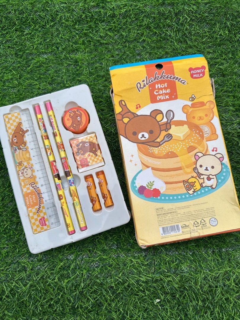 Rilakkuma Hot Cake Mix Stationery Gift Set (Category: Stationery & School Supplies) located in Manila. Submitted by ronoarabbit.ph (Listing ID 1466048896, Image 1). Description: ‼️Ngarag na ung box, bawal sa maarte‼️ - Theme: Rilakkuma Honey Milk Pancake - Colorway: Yellow, orange, and brown - Inclusions: 2 pencils, 1 ruler, 2 small caps, 1 eraser, and 1 circular stamp - Packaging: Comes in original box with plastic tray - Ideal for: Gifts, schoo