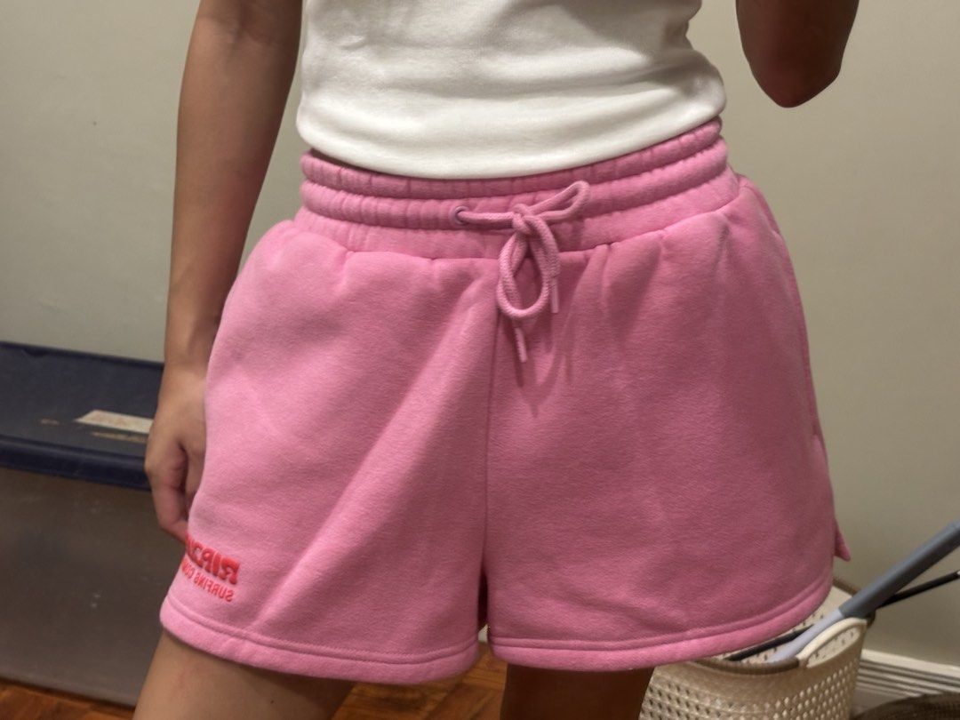 Rip Curl Pink Sweatshorts (Category: Shorts) located in Paranaque City. Submitted by domisclosett (Listing ID 1466097174, Image 3). Description: - Brand: Rip Curl - Color: Bright pink with small red embroidered logo on the right hem - Material: Super soft and comfy thick fleece fabric - Fit/Features: Thick elastic waistband with matching adjustable drawstring loc: parañaque/muntinlupa area mop: gcash, maribank, gotyme mod: lalamove or j&t, sf c/o