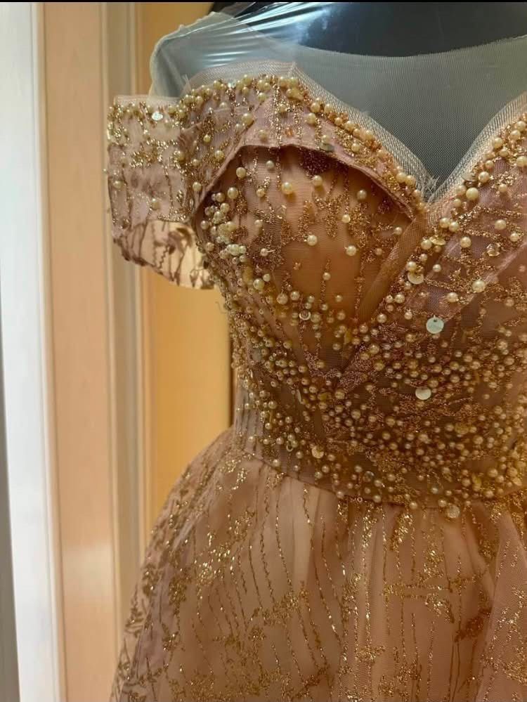 Rose Gold Ball Gown (Category: Evening dresses & gowns) located in Quezon City. Submitted by shanepenguin (Listing ID 1466103452, Image 3). Description: - Pearl and sequin embroidery detailing the bodice and neckline - Sheer tulle with shimmering metallic gold glitter patterns - Adjustable lace-up ribbon corset closure in the back for a perfect fit - Worn only once - Size Bust: 33-45 in Waist: 20-35 in Hips: 30-45 in.