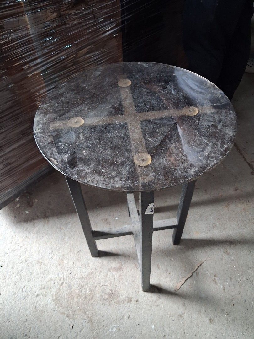 Round glass top side table with metal frame (Category: Tables & Sets) located in Taguig. Submitted by ssvcn (Listing ID 1466067200, Image 1). Description: - Heavy-duty round side table with solid metal build - Clear glass top secured by four suction cups - Sturdy X-shape metal legs for great stability - Ideal for the living room or balcony - Note: Surface has dust from storage and needs a quick clean.
