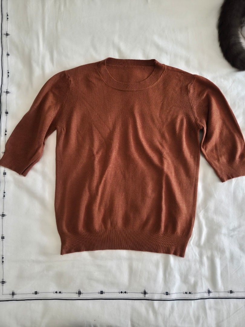Rust Orange Short Sleeve Knit Top Size M (Category: Blouses) located in Quezon City. Submitted by corrnic (Listing ID 1466032708, Image 2). Description: - Color: Rust orange - Size: M - Material: 30% viscose, 30% polyamide, 20% modal, 20% elastane - Design: Short sleeve knit top with a classic crew neckline - Details: Soft ribbed texture at the collar and hems - Condition/Fit: Great staple piece for layering or wearing on its own.
