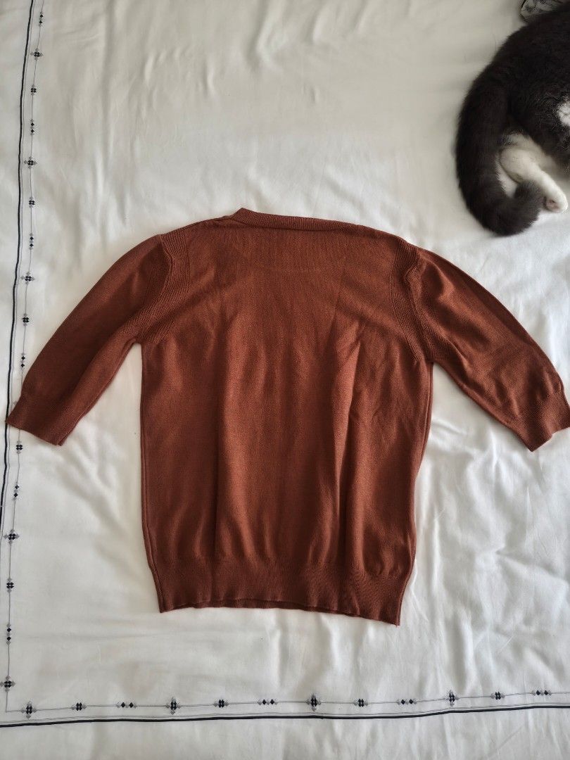 Rust Orange Short Sleeve Knit Top Size M (Category: Blouses) located in Quezon City. Submitted by corrnic (Listing ID 1466032708, Image 3). Description: - Color: Rust orange - Size: M - Material: 30% viscose, 30% polyamide, 20% modal, 20% elastane - Design: Short sleeve knit top with a classic crew neckline - Details: Soft ribbed texture at the collar and hems - Condition/Fit: Great staple piece for layering or wearing on its own.