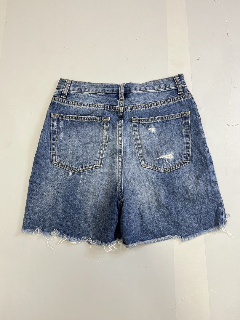 Saint Laurent Distressed Denim Shorts Size 26 (Category: Shorts) located in Mabalacat. Submitted by aas_thriftfings (Listing ID 1465991686, Image 2). Description: - Brand: Saint Laurent - Size: 26 (inner label) - Color/Wash: Medium blue - Details: Distressed with front rips and back pocket wear - Hem: Raw frayed bottom - Closure: Button fly with branded hardware - Style: Classic five-pocket design - Condition: Excellent pre-loved condition - Mode