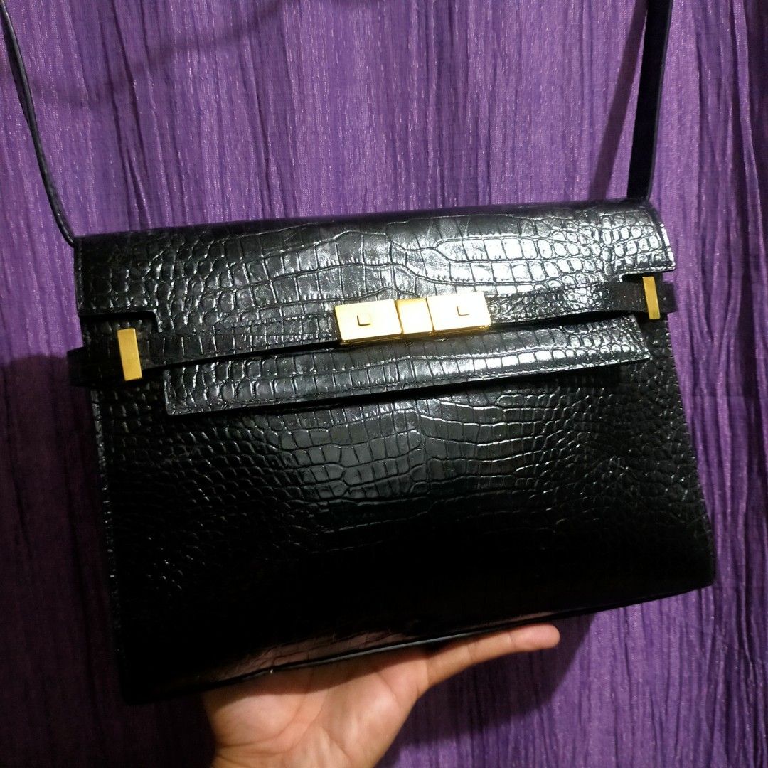 Saint Laurent Manhattan leather handbag (Category: Luxury Bags & Wallets) located in Zamboanga. Submitted by _oliverbmth (Listing ID 1466026713, Image 3). Description: - Brand: Saint Laurent (YSL) Manhattan Shoulder Bag - Material: Black crocodile-embossed leather - Hardware: Gold-tone with engraved branding - Closure: Flap with stylish belt accent - Strap: Adjustable shoulder strap - Condition: Clean interior, well-kept with minor surface scratc