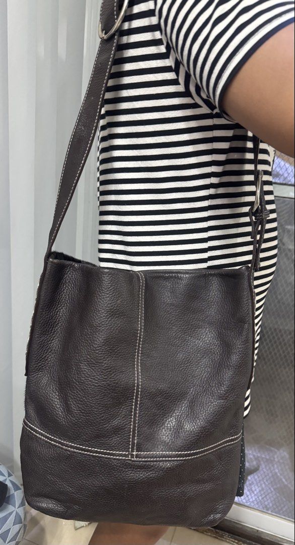 Salvatore Ferragamo patchworked shoulder bag (Category: Tote Bags) located in Malolos. Submitted by urban_thrift_09 (Listing ID 1466059168, Image 3). Description: -vintage Salvatore Ferragamo patchworked shoulder bag crafted from a combination of grained dark brown leather and black pony hair (calf hair). -It features prominent white contrast stitching that blocks out the textured panels, an adjustable leather shoulder strap with a silver-toned b
