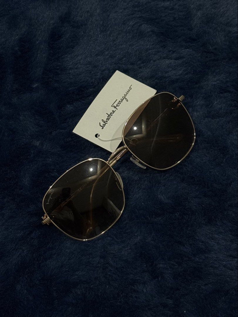 Salvatore Ferragamo Sunglasses with Tag (Category: Sunglasses & Eyewear) located in Manila. Submitted by snowflakesi (Listing ID 1465970146, Image 1). Description: - Frame: Classic metal design with signature Gancio hardware at the hinges - Lenses: Dark gradient for stylish sun protection - Perfect for daily wear or gifting Helping my ninang sell authentic sunglasses. ☀️ .