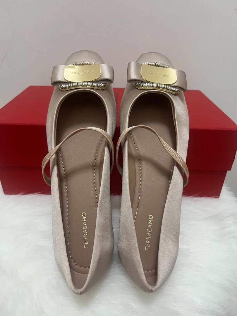 Salvatore Ferragamo Vara Ballet Flats (Category: Sneakers & Footwear) located in Paoay. Submitted by rvf1230 (Listing ID 1465992516, Image 2). Description: - Brand: Salvatore Ferragamo - Style: Champagne satin Mary Jane flats - Detailing: Gold metallic logo plaque framed with sparkling crystals on the toe - Fit: Comfortable elastic strap across the top for a secure fit - Inclusions: Original red storage box included - Condition: Excellent, well-m