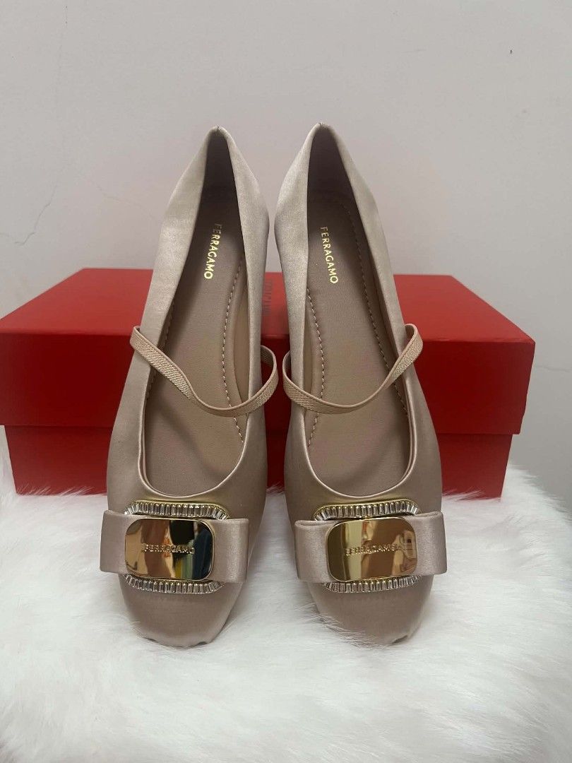 Salvatore Ferragamo Vara Ballet Flats (Category: Sneakers & Footwear) located in Paoay. Submitted by rvf1230 (Listing ID 1465992516, Image 1). Description: - Brand: Salvatore Ferragamo - Style: Champagne satin Mary Jane flats - Detailing: Gold metallic logo plaque framed with sparkling crystals on the toe - Fit: Comfortable elastic strap across the top for a secure fit - Inclusions: Original red storage box included - Condition: Excellent, well-m