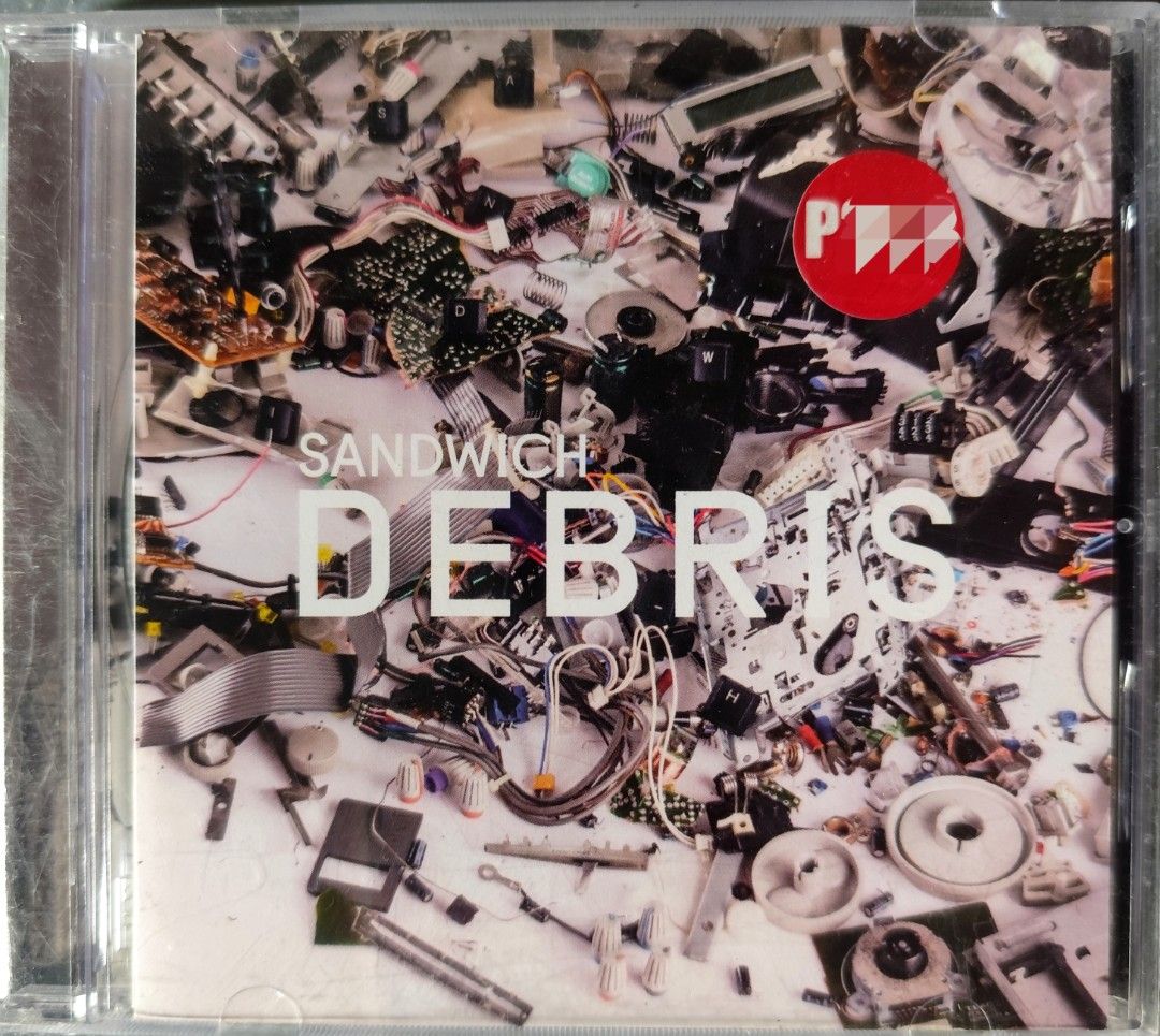 Sandwich Debris CD Album (Category: CDs & DVDs) located in Valenzuela. Submitted by xjepsx (Listing ID 1466052622, Image 1). Description: - Album: Sandwich - Debris - Format: Standard jewel case CD (playable disc) - Cover Art: Electronic scrap, computer parts, and wires - Special Feature: Includes original red promo sticker on the front - Condition: Light surface scuffs on the jewel case from storage; disc is in good playing condition - Perfect f