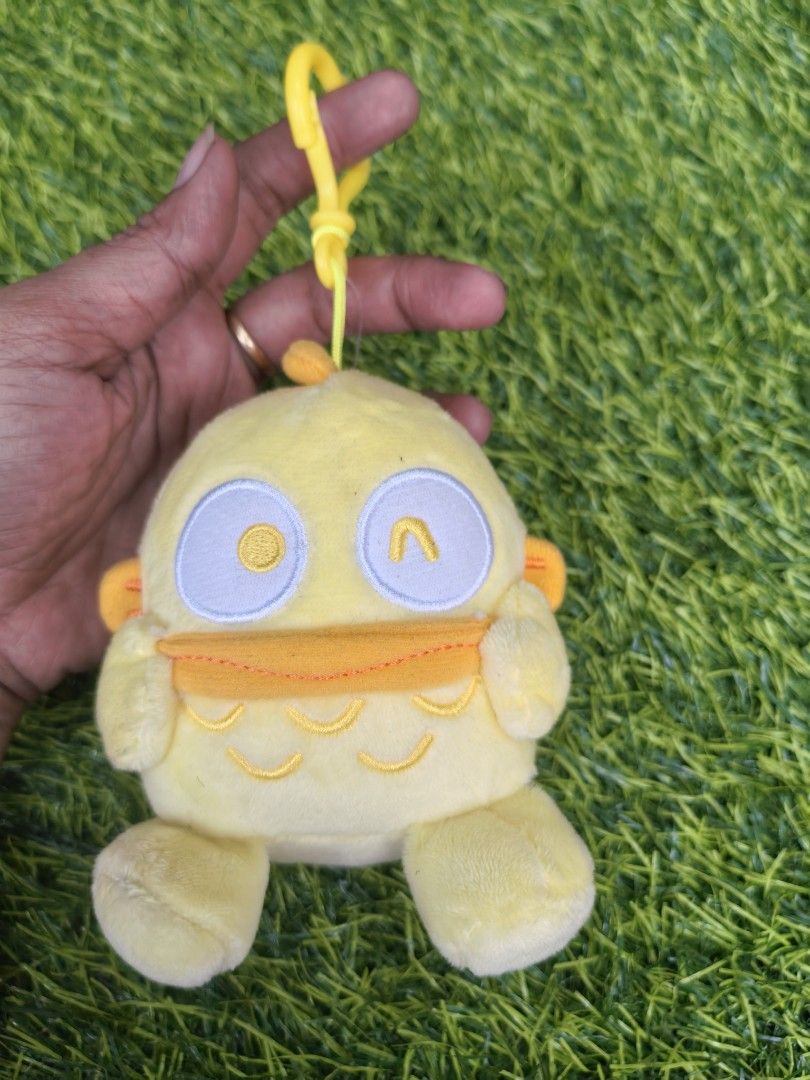 Sanrio Licensed Yellow Duck Character Plush Keychain (Category: Plushies & Soft Toys) located in Paranaque City. Submitted by furugiyafinds (Listing ID 1466035764, Image 1). Description: - Official Sanrio Licensed plush keychain - Adorable yellow bird design with embroidered facial details - Features a vibrant orange beak and matching feet - Equipped with a sturdy yellow plastic clip for easy hanging.