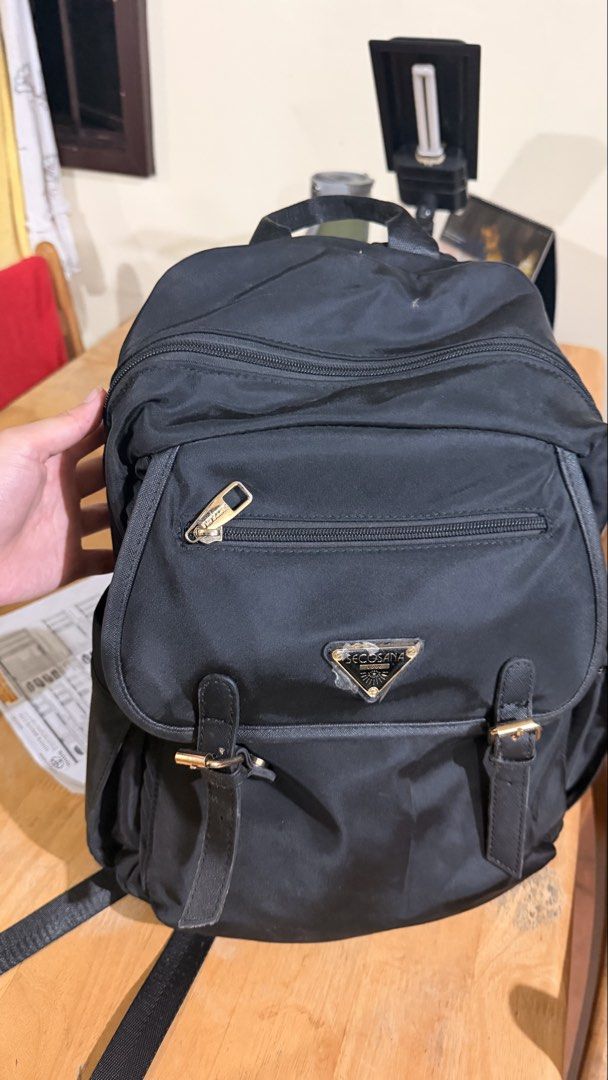 Secosana Black Backpack with Gold Hardware (Category: Backpacks) located in Manila. Submitted by swiftdragon.6d8469 (Listing ID 1466065845, Image 1). Description: - Brand: Secosana - Material: Durable black nylon with gold-tone hardware -Adjustable shoulder straps.
