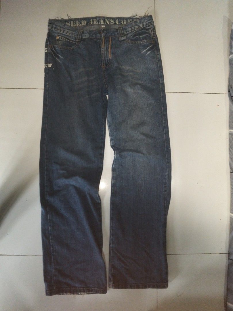 Seed Jeans Corp Straight Cut Denim Pants (Category: Jeans) located in Manila. Submitted by cxrlsobasedd_ (Listing ID 1465990049, Image 2). Description: - Brand: Seed Jeans Corp - Color: Classic blue wash - Fit: Straight leg, standard five-pocket style - Details: Graphic print on back pocket and unique distressed raw hem along the waistband - Vibe: Vintage streetwear aesthetic.