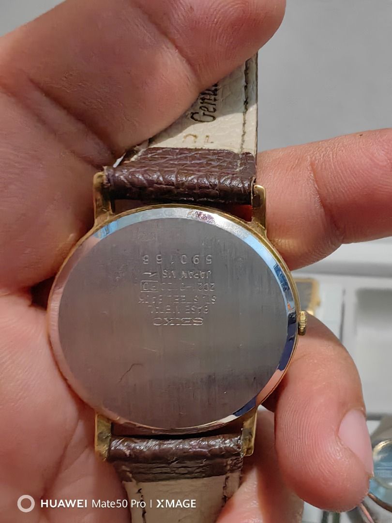 Seiko Quartz Gold Dial Brown Leather Strap Watch (Category: Women's Watches) located in Manila. Submitted by lucky_yonathan (Listing ID 1466080261, Image 3). Description: - Brand: Seiko Quartz Watch - Dial: Clean gold dial with minimal markers and slim hands - Case: Gold-tone round case with minor scuffs around the bezel - Strap: Textured brown leather strap with standard pin buckle closure (shows visible wear) - Performance: Keeps accurate time 