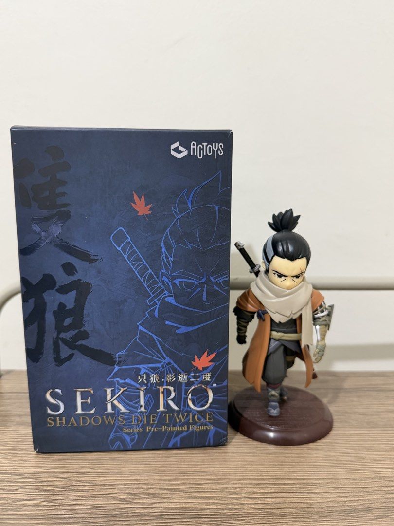 Sekiro Shadows Die Twice Figure (BIB) (Category: Figurines & Statues) located in Magalang. Submitted by xeevain (Listing ID 1466049806, Image 1). Description: - Brand: AcToys (Sekiro Shadows Die Twice Series) - Condition: BIB (Back in Box) / Pre-owned - Details: Chibi-style pre-painted figure mounted on a sturdy brown base - Flaw Note: One sword accessory is detached/broken (please check photos) - Packaging: Comes with original plastic blister an