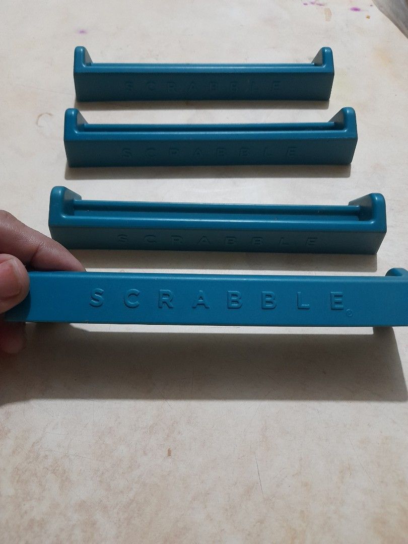 Set of 4 Scrabble Tile Racks (Category: Board Games & Puzzles) located in Bocaue. Submitted by marajapansurplus (Listing ID 1466068557, Image 1). Description: - Set of 4 blue Scrabble tile racks - Great as replacement pieces or extra holders for game night - Made of durable molded plastic with raised branding on the back - Clean condition with no major marks.