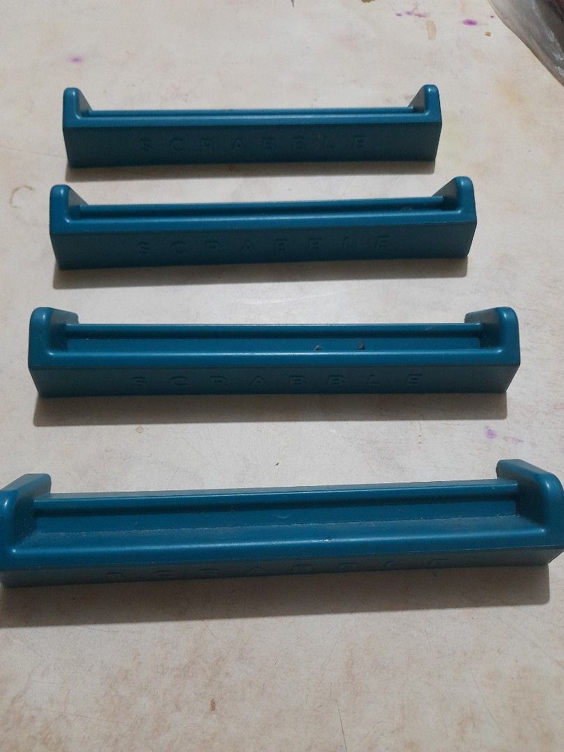 Set of 4 Scrabble Tile Racks (Category: Board Games & Puzzles) located in Bocaue. Submitted by marajapansurplus (Listing ID 1466068557, Image 2). Description: - Set of 4 blue Scrabble tile racks - Great as replacement pieces or extra holders for game night - Made of durable molded plastic with raised branding on the back - Clean condition with no major marks.