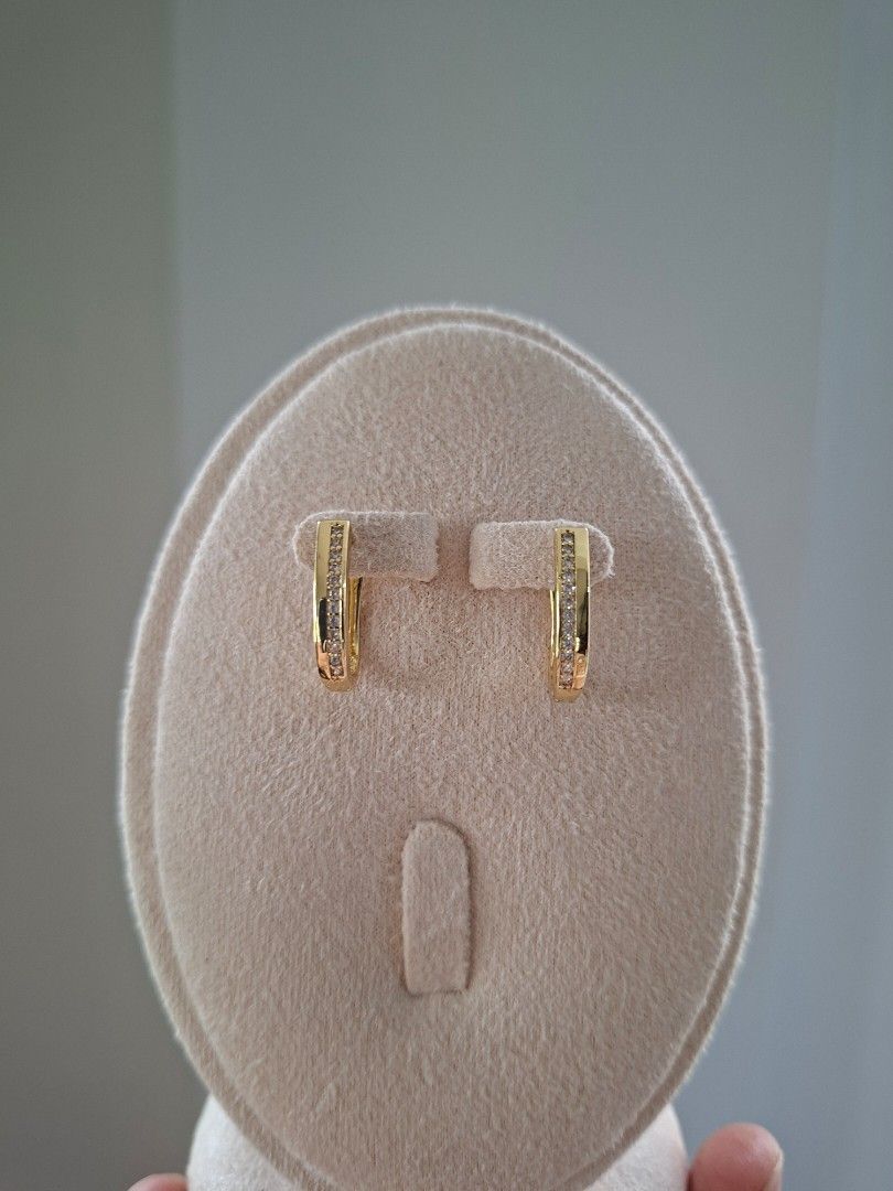 Sharp Oval Shape Half Side Stones Gold Hoop Earrings (Category: Earrings) located in Dasmarinas. Submitted by danabrie22 (Listing ID 1466056819, Image 1). Description: very well-made, excellent crafstmanship 10/10 condition brand new stainless steel & white-colored cubic zirconia stones made in Hongkong.