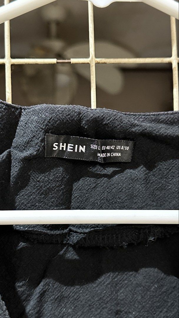 Shein Black Cropped Button Vest Size L (Category: Sleeveless) located in Quezon City. Submitted by nsseller (Listing ID 1466108132, Image 2). Description: - Brand: Shein - Color: Solid black - Size: Large (EU 40/42, US 8/10) with tag attached - Design: V-neckline, sleeveless, textured fabric, and 3 front buttons with light-colored detailing - Style: Cropped vest, great for layering.