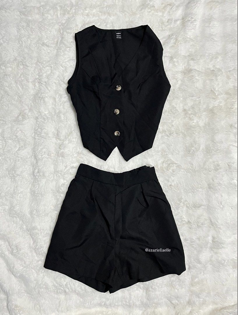 SHEIN Black Vest and Shorts Set (Category: Sets or Coordinates) located in Navotas City. Submitted by azariellaelle (Listing ID 1466035222, Image 1). Description: - Brand: SHEIN - Color: Solid black - Set includes: Sleeveless V-neck vest with 3 front buttons and matching pleated shorts with structured waistband - Material: Smooth, lightweight fabric ideal for warm weather - Style: Casual, chic, and easy to mix and match with other closet staples.