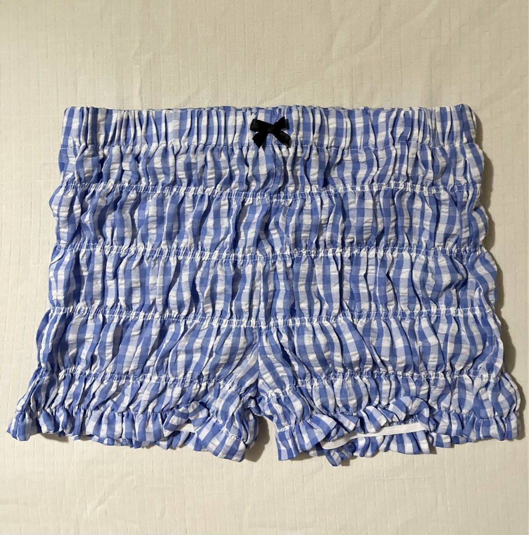 SHEIN Blue Gingham Ruffle Smocked Shorts Size S (Category: Shorts) located in Quezon City. Submitted by getitrightaway.ph (Listing ID 1466069317, Image 2). Description: - Brand: SHEIN - Size: Small (Fits EU 36 / US 4) - Design: Blue and white gingham print with a cute front bow and ruffle hems - Comfort: All-over smocked stretchy elastic material - Material: 100% polyester, machine washable - Condition/Use: Great for lounging or casual wear.