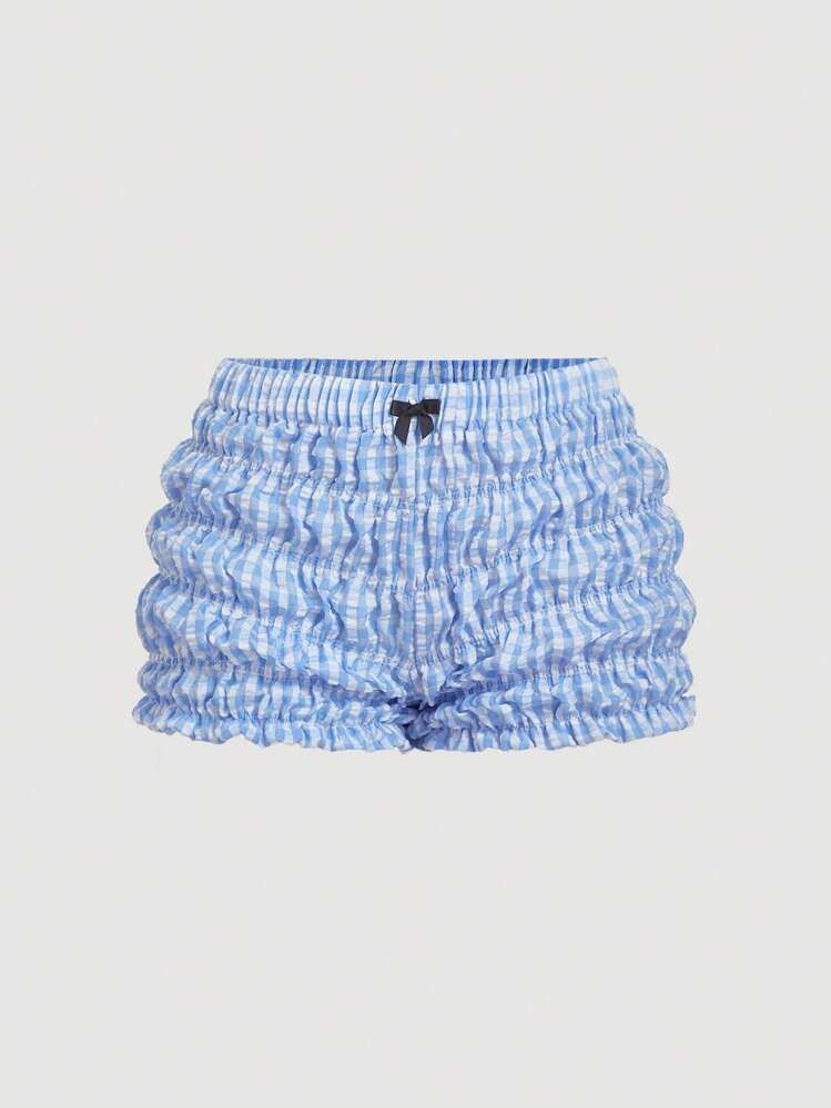 SHEIN Blue Gingham Ruffle Smocked Shorts Size S (Category: Shorts) located in Quezon City. Submitted by getitrightaway.ph (Listing ID 1466069317, Image 1). Description: - Brand: SHEIN - Size: Small (Fits EU 36 / US 4) - Design: Blue and white gingham print with a cute front bow and ruffle hems - Comfort: All-over smocked stretchy elastic material - Material: 100% polyester, machine washable - Condition/Use: Great for lounging or casual wear.