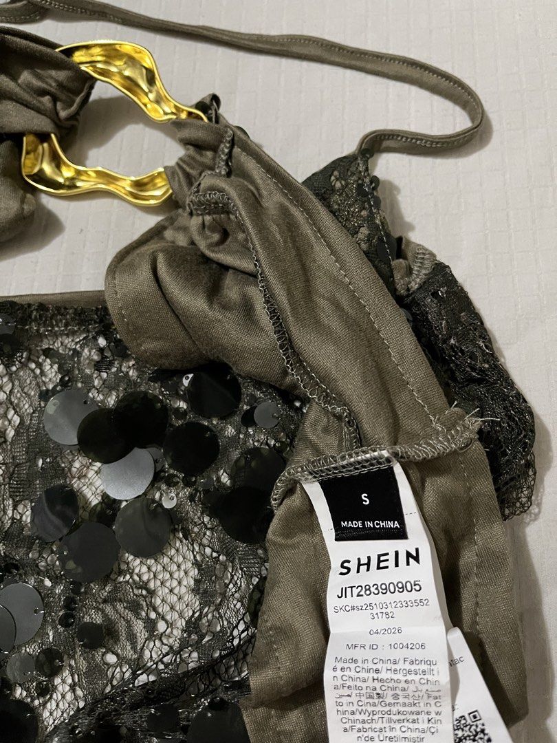 SHEIN Green Sequin Halter Crop Top Size S (Category: Sleeveless) located in Quezon City. Submitted by getitrightaway.ph (Listing ID 1466043773, Image 3). Description: - Brand: Shein - Size: S - Color/Style: Olive green halter crop top with shiny black sequins and lace overlay - Features: Open back, secure halter ties, and trendy gold hardware ring connector - Condition: Brand new, only tried on, tag still attached - Perfect for: Nights out, parti